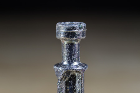 Bolts and screws for metal on a workshop table. Joinery accessories for furniture repair. Light background.の写真素材