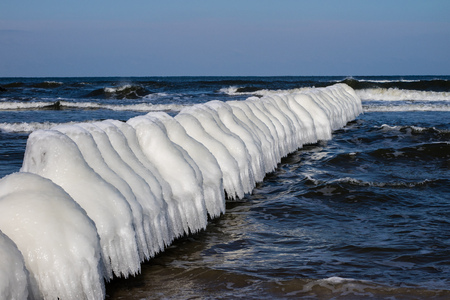 Baltic Sea in Poland. Sea shore and falachron with icy wooden pegs. Season winter.の写真素材