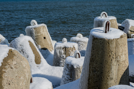 Baltic Sea in Poland. Entrance to the port, ice-covered concrete breakwater. Season winter.の写真素材