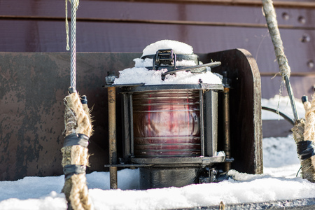 Ship signal lamp. Ship lighting on board a floating vessel in the port. Winter seasonの写真素材