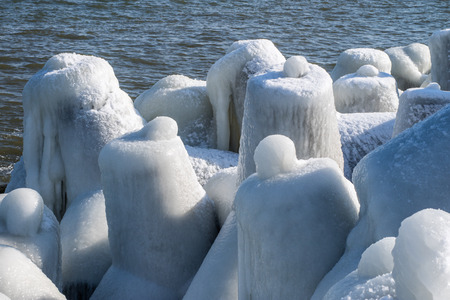 Baltic Sea in Poland. Entrance to the port, ice-covered concrete breakwater. Season winter.の写真素材