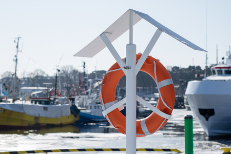 Fishing boats in the Polish fishing port on the Baltic. Fishing accessories, nets and ropes on a boat for fishing. Winter season.の写真素材