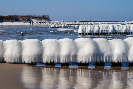 Baltic Sea in Poland. Sea shore and falachron with icy wooden pegs. Season winter.の写真素材