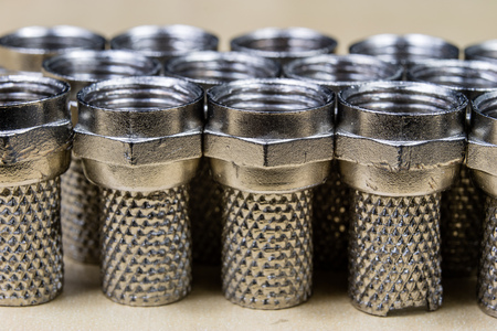 Plug type F on a wooden workshop table. Telecommunications connectors for building a telecommunications network. Dark background.の写真素材