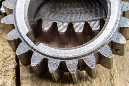 Metal gears covered with a layer of oil in a larger image. Spare parts for machines and devices. Dark background.の写真素材