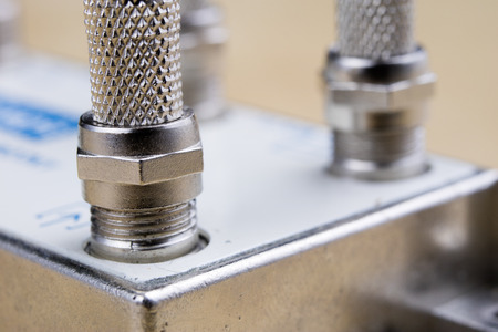 F-type connector in the enlargement. Accessories used for the installation of cable television. Light background.の写真素材