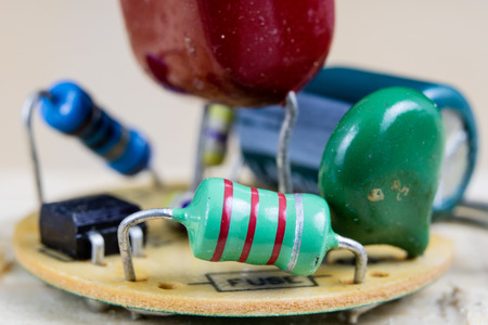 Electronics in high magnification. Resistors and diodes are soldered to an electronic board. Dark background.の写真素材