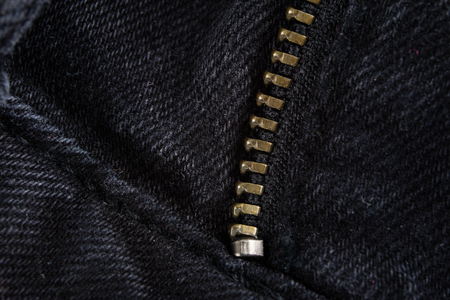 Denim shorts under magnification. Trouser zipper, belt loops and other small items in jeans. Light background.の写真素材