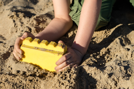 Locks on the sand. Fun in the sand on the beach on a sunny day. Season of the spring.の写真素材