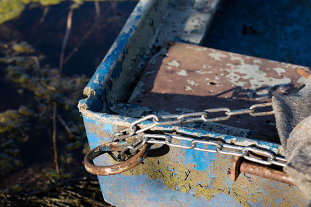 Chain for securing a fishing boat against theft. Moored fishing boat. Season of the spring.の写真素材