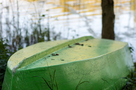 A fishing boat moored to the shore of the lake. Old fishermen's boat prepared for fishing on lakes....