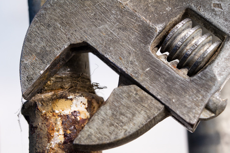 Hydraulic wrench and water installation. Accessories for hydraulics mechanics when repairing old water lines. Dark background.の写真素材