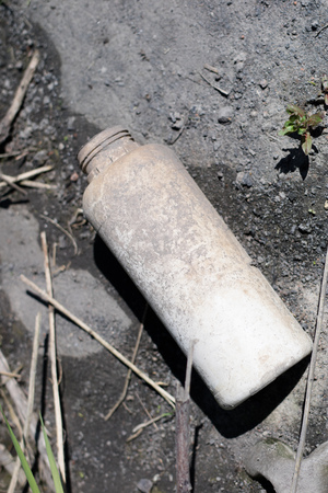 Garbage left in the forest. Littered with various plastic impurities. Season of the spring.の写真素材