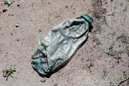 Garbage left in the forest. Littered with various plastic impurities. Season of the spring.の写真素材