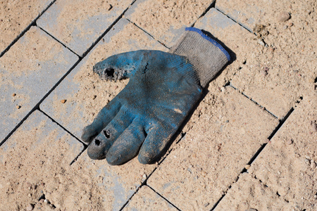 Construction site for a new road for cars. Laying paving blocks, new wells along the road. View of the construction site.の写真素材