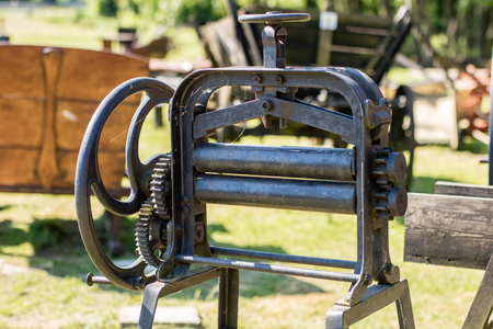 Old mangle for housework. Devices that facilitate housework in an old house. Season of the spring.
