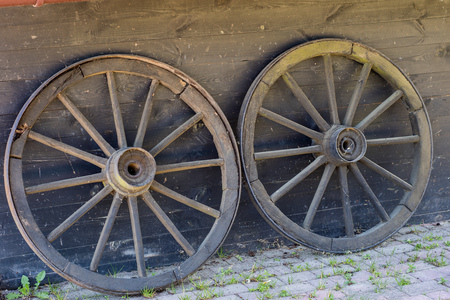 Old wooden wheels for horse cart. Open-air museum where various types of cars and wheels are shown....