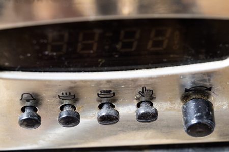 An old dirty gas kitchen. Device for preparing dishes in the kitchen. Dark background.の写真素材