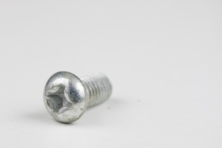 Screw head on a white table. Accessories for screw connections. Light background.の写真素材