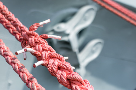 Ship mooring rope on the port wharf. Harbor bollard for large naval vessels. Season of the summer.の写真素材