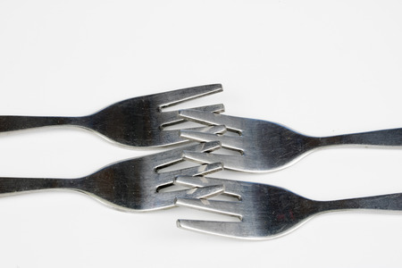 Cutlery arranged on a white kitchen table. Accessories for kitchen and restaurant use. White...