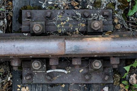 Old railway rails. Connecting railway rails in old technology. Season of the summer.の写真素材