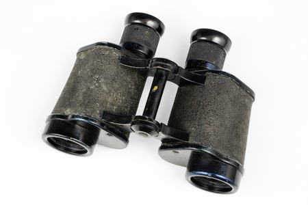 Old metal binoculars on a white table. Old military accessories for infantry. White background.の写真素材
