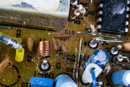 Old integrated circuits in an analog radio receiver. Resistors, transistors and other circuits on an...