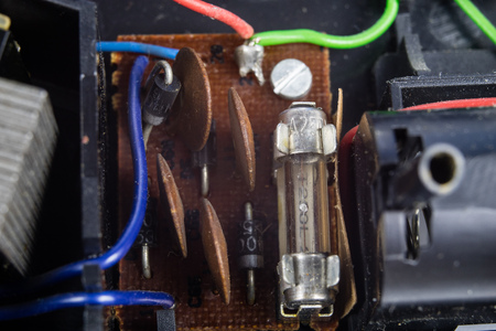 Old integrated circuits in an analog radio receiver. Resistors, transistors and other circuits on an old integrated circuit board. Workplace - workshop.の写真素材