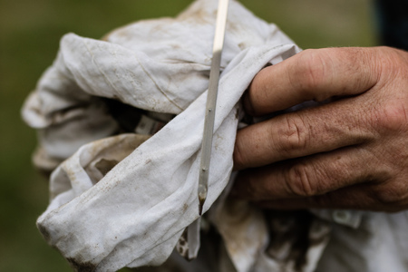 Car dipstick for oil level measurements. Checking the parameters of the car engine. Place - workshop.の写真素材