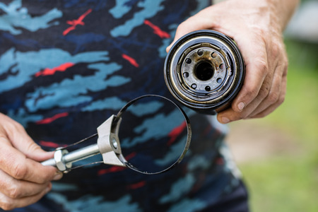 Car oil filter. Spare parts for repairing cars in the workshop. Place - car workshop.の写真素材