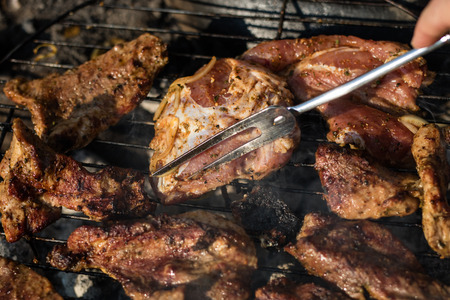 Tasty pork on the grill. Grilled delicacies for a party in a home garden. Season of the summer.の写真素材