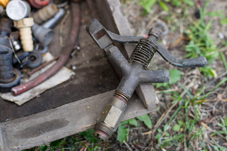 Garden sprinkler for watering vegetables and flowers. Old garden accessories. Season - summer.