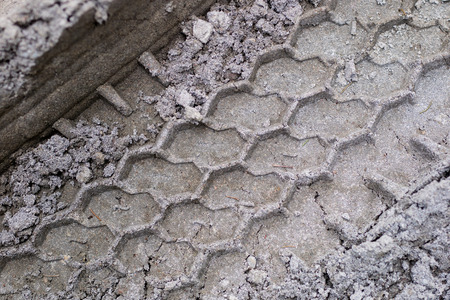Wheel tracks from the car on the sand. Impressed tire tread. Season of the summer.