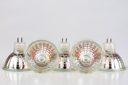 Halogen bulb on a white table. Modern interior lighting of apartment buildings. White background.
