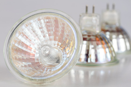Halogen bulb on a white table. Modern interior lighting of apartment buildings. White background.の写真素材