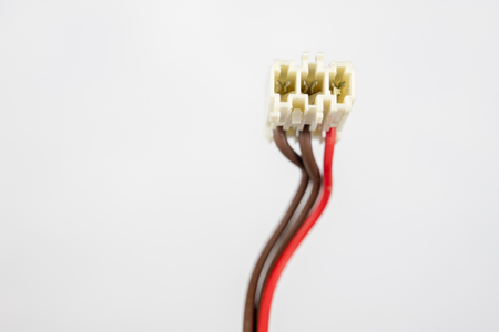 Old cables for electrical devices on a white table. Electrical connectors from household appliances. White background.の写真素材