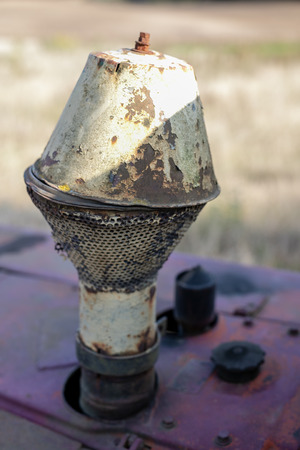 An old bulldozer for leveling the ground. Equipment for earthworks on a guarded field. Season of the autumn.の写真素材