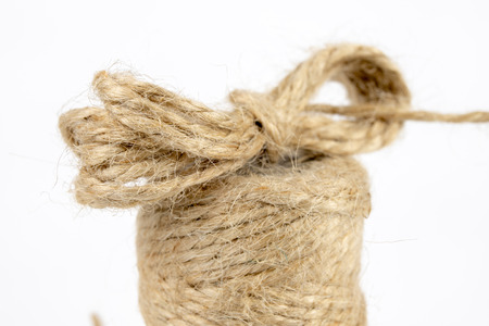 Twine for packaging parcels and a sharp knife. Cable for binding parcels sent by post. White background.の写真素材