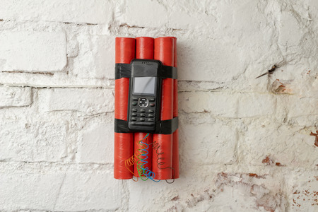 Dynamite sticks with time igniter. Explosive material with ignition connected to a mobile phone....