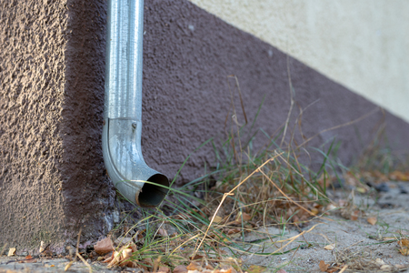 Gutter draining rainwater. The building is equipped with drainage of rainwater from the roof. Season of the summer.の写真素材