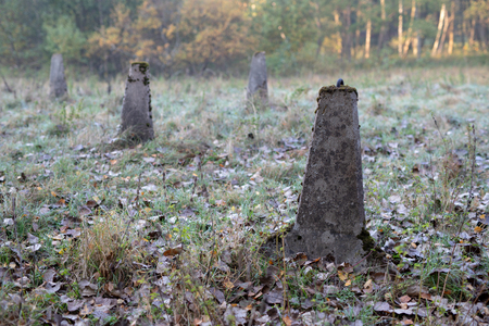 Dragon's teeth arranged in a wet area. Firewall for tanks from World War II. Season of the autumn.の写真素材