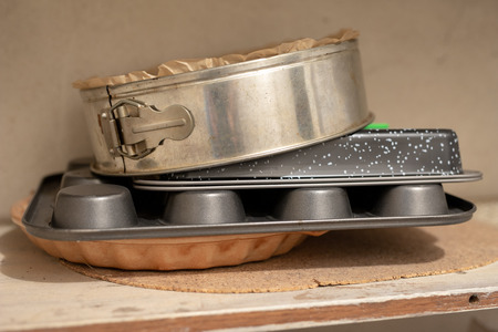 Old baking molds on an old kitchen table. Baking accessories in the kitchen. wooden table.の写真素材