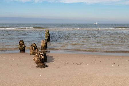 Old breakwater bollards on the sea beach. Coast in central europe. Season of the autumn.の写真素材
