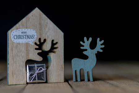 Christmas decorations on the kitchen table. Wooden Christmas figurines prepared for decorating a tree. Dark background.の写真素材