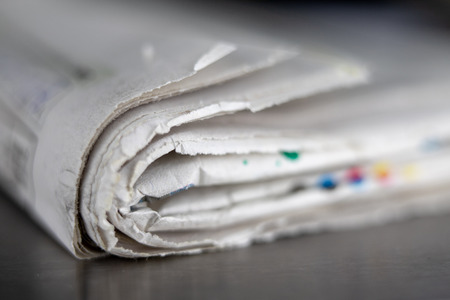 Waste paper bound with a gray cord. Old papers and cardboard intended for recycling. Dark background.の写真素材