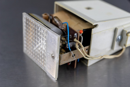 Old flash lamps on a metal table. Photo accessories from central europe. Dark background.の写真素材