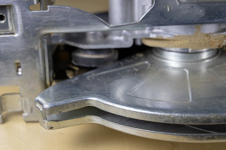 Circular saw on a workshop table. Tools for a carpenter in a home workshop. Dark background.