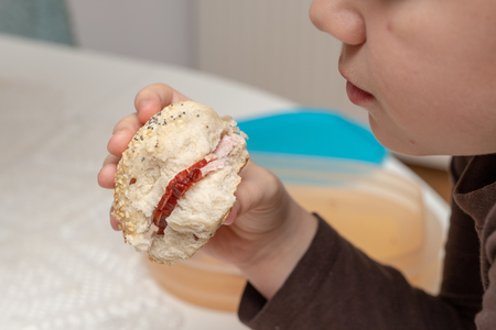 Tasty wheat roll on the kitchen table. Preparing dinner with fresh bread and butter. Autumn background.の写真素材