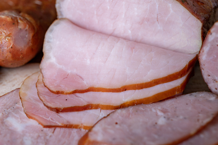 Tasty fresh sausages on the kitchen table. Treats prepared for the home ceremony. Light background.の写真素材